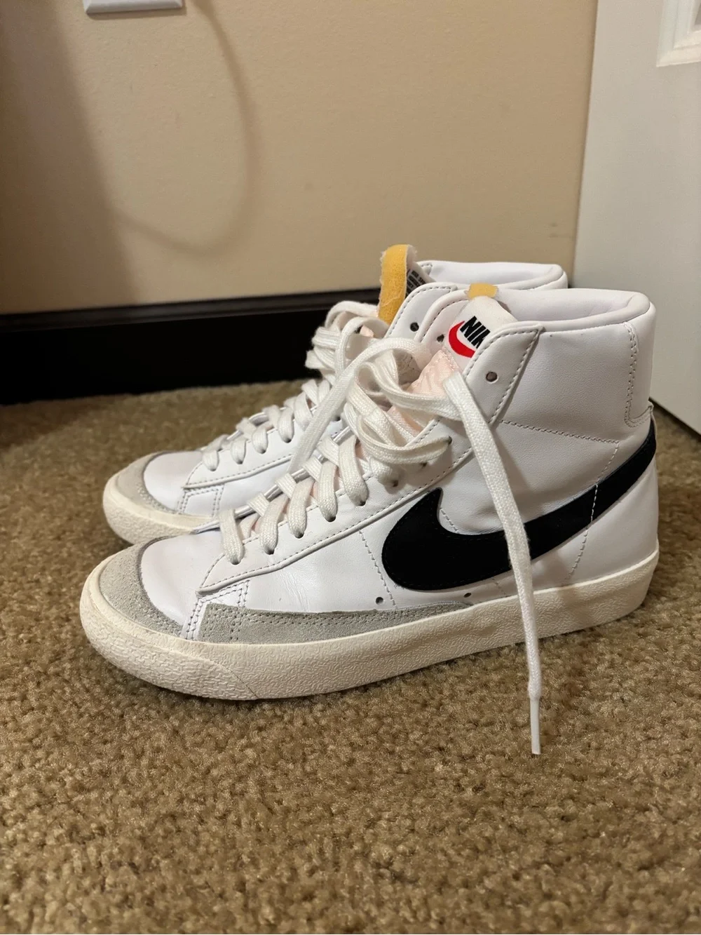 Nike White High-Top Sneakers with Black Swoosh and Yellow Tongue